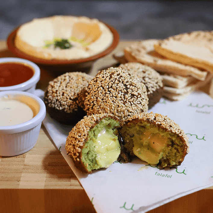 Sesame-crusted falafel cut open, fried to order